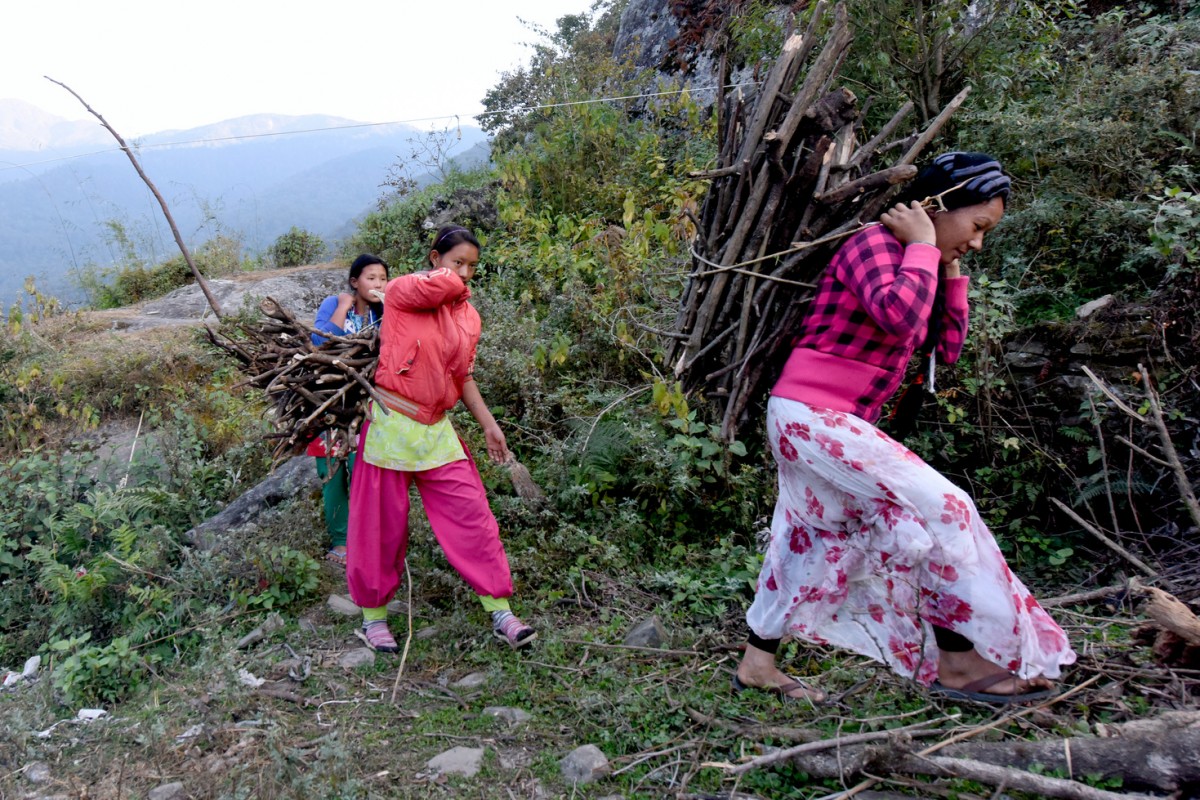 In November 2015, earthquake-displaced school student Rashmi Tamang leads her friends as they return from the forest after collecting firewood in Dhunche, the district headquarters of Rasuwa. Since the earthquake on 25 April 2015 devastated their homes and schools in Haku Village Development Committee in the district, Tamang and her 14 fellow school mates have been living in a tented hostel for the past eight months to continue their education in a nearby UNICEF-supported temporary learning centre (TLC). In the midst of winter, life has become hard for the students as they are also affected by the fuel crisis and shortage of essential supplies including fuel and food.