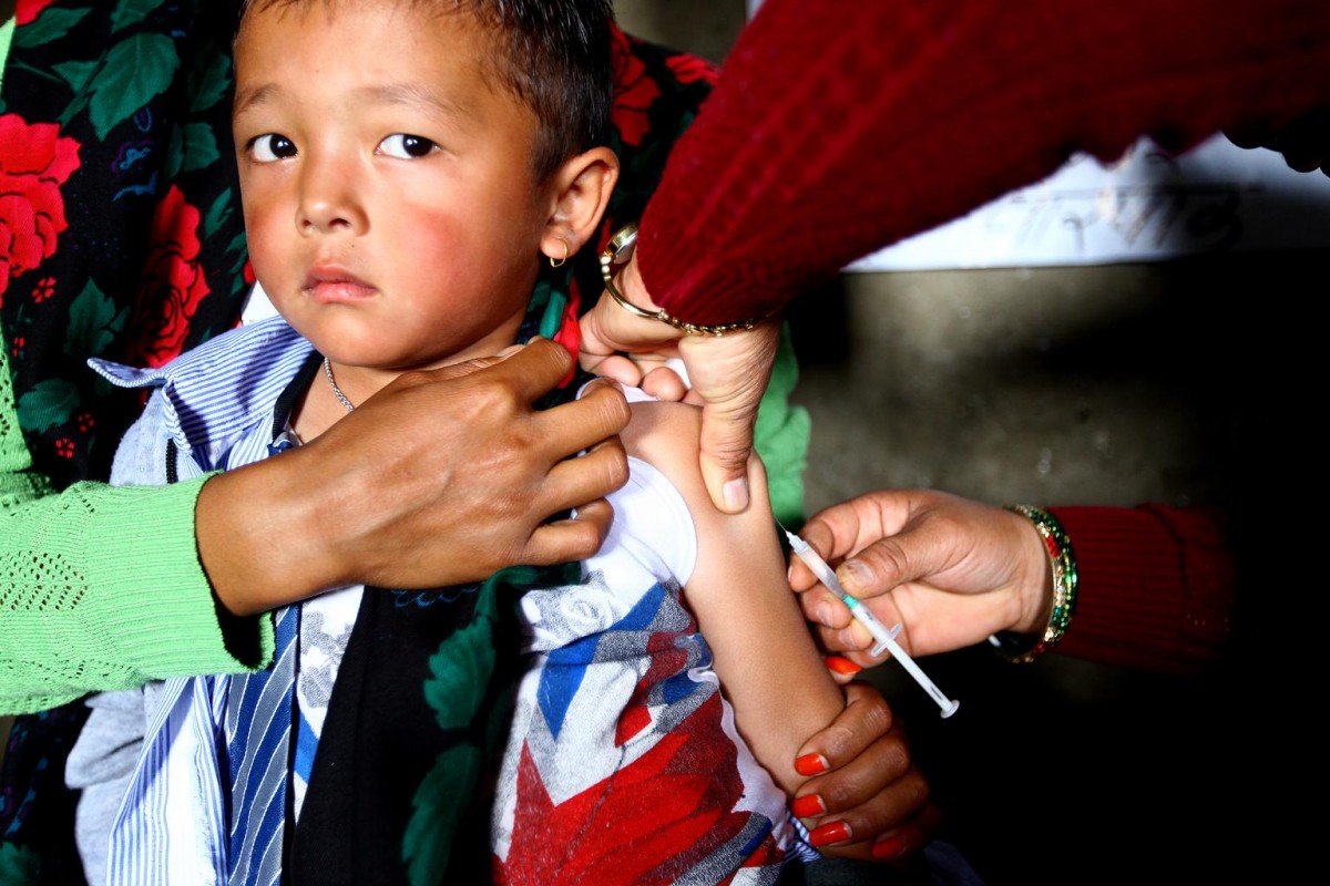 A young boy is administered measles and rubella vaccine during UNICEF-supported measles, rubella and polio vaccination campaign conducted at Barpak Village Development Committee (VDC) health post in Gorkha District, the epicentre of the April 25 earthquake.