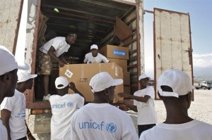 UNICEF and other workers load ECD kits onto a truck, at a UNICEF warehouse in Port-au-Prince, the capital. The supplies also include care packages for children, part of a UNICEF collaboration with the United States Fund for UNICEF and varied private sector partners. Both the ECD kits and the child care packages are destined for residential child care centres and UNICEF-supported child-friendly spaces for children affected by the earthquake. Some of the men wear T-shirts bearing the UNICEF logo. [#2 IN SEQUENCE OF NINE] On 5 February 2010 in Haiti, UNICEF Early Childhood Development (ECD) kits are being distributed in Port-au-Prince, the capital, to residential child care and child-friendly' spaces that are providing services for children affected by the 12 January earthquake. The quake killed an estimated 112,000 people and left 1 million homeless. Major government and private infrastructure were destroyed or heavily damaged. In Port-au-Prince, as many as 460,000 people continue to live in makeshift settlements, despite an exodus of up to 482,000 from the devastated city. Each ECD kit, for use by up to 50 children aged 0-6 years, contains age-appropriate educational materials and learning tools to help caregivers provide a range of activities that encourage child development and social interaction. Materials include art supplies, hand puppets for story-telling, puzzle blocks and memory games, as well as water containers and soap to promote proper hygiene. UNICEF created the kit to help support the development and learning of children aged 0-6 years who are affected by emergencies. This distribution is one of the first in a plan to provide 1,000 kits to centres serving small children affected by the quake.