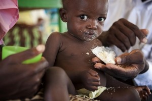 One-and-half year old Cherline Noel, who is malnourished, eats a high-energy biscuit in a baby tent in Caradeux, a displacement camp in Port-au-Prince, the capital. The tent is managed by the NGO Union des Amis Socio-Culturels dAction en Development (UNASCAD), a UNICEF partner. Baby tents are safe havens for women with small children, where they can learn about proper infant care and receive medical assistance. [#3 IN SEQUENCE OF THREE] In March 2011 in Haiti, malnutrition remains a major threat to childrens health. Some 25 per cent of children have low birthweight, and approximately 22 per cent of children under age five suffer moderate to severe malnutrition. As many as 300,000 Haitian children suffer from chronic malnutrition, and up to half of child deaths in the country are caused by malnutrition. Complicating this situation is the countrys slow recovery from the 12 January 2010 earthquake, a disaster that killed 220,000 people and left more than a million people homeless. UNICEF is working with a variety of partners to increase access to nutrition programmes, particularly in camps for those who remain displaced. UNICEF and partners are working to educate parents about proper nutrition for their children and to distribute therapeutic foods to those in need.