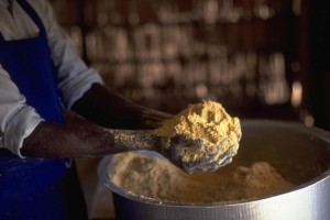 In December 1999 in Uganda, a man worker prepares a high-protein corn soya blend (CSB) for distribution to women to feed their children, at the UNICEF-assisted Pabbo camp for internally displaced persons in the northern district of Gulu.