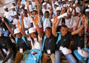 26 November 2010, children wearing UNICEF caps and T-shirts raise their hands at the closing ceremony of the National Youth Forum on Children's Rights that took place at the Djado Sekou Cultural Centre in Niamey, the capital of Niger. Child participation in decision-making processes is still a myth in Niger but some noteworthy progress are being achieved thanks to the myriad of efforts undertaken by UNICEF and partners to boost children's expression. Children's viewpoints on matters that concern them can contribute to the creation of a child-friendly environment respectful of their rights in Niger. In Niger more than 9 out of 10 children are deprived of at least one right essential to their well-being, and almost 8 in 10 children are deprived of at least two essential rights simultaneously. UNICEF Niger creates communication platforms that provide space for children to freely express themselves and by advocating for more airtime on radio and television to broadcast shows produced by and for children. At the end of 2010 UNICEF Niger organized a mega children's forum (November 24-26, 2010) bringing together 160 children coming from the country's 36 districts. The forum gave children the unique opportunity to speak out and voice their concerns directly to national authorities, researchers, journalists and UN staff. Children's messages were broadcast on television and radio stations on a daily basis during and after the presidential election in 2010.