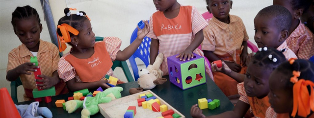 Children play with Early Childhood Development (ECD) kits in Haiti.