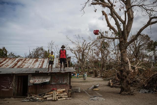 (Foreground) a child and an elderly man stand on the roof of a dwelling damaged Cyclone Pam, on Ifira Island, just off the coast of the main island of Efate. On 25 March 2015 in Vanuatu, 166,000 people remain affected following the destruction caused by Tropical Cyclone Pam, which hit the South Pacific island nation on 13 March. Nearly 60,000 of them are children. The Category 5 storm damaged infrastructure and disrupted key services, putting childrens health, safety and education at risk. Power, water supply and other critical infrastructure have been affected across the archipelago, including in Port Vila, the capital, on Efate Island. Health and other vital services in many areas have also been disrupted, including access to safe drinking water and sanitation facilities, leading to increased risk of water- and vector-borne diseases. Many homes and schools have also been damaged or destroyed. At least 70,000 school-aged children are out of school; and early childhood centres, schools, churches and community halls are serving as evacuation centres and as emergency shelters. Working with the Government and partners, including other United Nations organizations, UNICEF is supporting water, sanitation and hygiene (WASH), health, education, nutrition, protection and other critical services in affected communities. UNICEF, with the World Health Organization (WHO) and the Ministry of Health, is also coordinating a measles-rubella prevention campaign in the country where immunization rates are low, and which experienced a measles outeak in early March. UNICEF is also supporting communities on Tuvalu and Solomon Island, which have also been affected by Tropical Cyclone Pam.