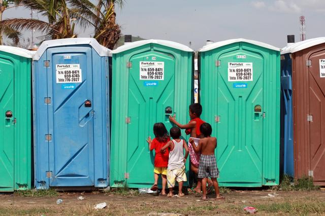 On 6 December, children stand outside portable toilets, in the Astrodome evacuation centre in Tacloban City  among the areas worst affected by Typhoon Haiyan  in Leyte Province, Eastern Visayas Region. The toilets bear the UNICEF logo. From 5 to 7 December in the Philippines, Government-led emergency relief and recovery operations continued in the wake of the destruction caused by Typhoon Haiyan (known locally as Yolanda), which hit the Philippines on 8 November. Casualties have reached 5,759, and 1,779 people remain missing. Some 15 million people, including 6.7 million children, have been affected. Some 4 million people, including 1.6 million children, have been displaced. The storm, one of the strongest ever to make landfall, also destroyed homes, schools, hospitals, roads, communications and other basic infrastructure, and damaged power and water supply systems. Though main roads were passable as of mid-November, debris continues to hamper access to remote areas. To date, UNICEF response has ensured that 360,500 people in affected areas have access to clean water. Hygiene kits have been provided to 100,000 people, and toilet slabs and portable toilets are serving 25,000 people. Other support includes screenings for malnutrition in children under age 5; efforts to reunify unaccompanied and separated children with their families; the establishment of temporary learning spaces that have benefitted over 10,000 children; and the assessment of damage to the cold chain in affected areas. UNICEF has appealed for US$61.5 million to cover its response to Typhoon Haiyan through May 2014.