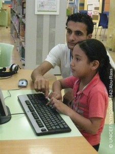 Childs View  A man teaches computer skills to a girl at the Al Qattan Centre for the Child in Gaza City, in the Gaza Strip. The photograph was taken by Hedab Abu-Rass, 18, one of 19 participants in a UNICEF-organized child photography workshop.  In August 2009 in the Occupied Palestinian Territory (OPT), UNICEF held photography workshops for children in both the West Bank and the Gaza Strip. The workshops overarching theme was child rights, part of global tributes to the 20th anniversary of the Convention on the Rights of the Child on 20 November of this year. In the Gaza Strip, the workshop was held in Gaza City with 19 young people, aged 12-19, at the Al Qattan Centre for the Child, a local UNICEF-assisted cultural and educational NGO. Guided by UNICEF photographer Giacomo Pirozzi, participants selected their own topics to photograph, including: examples of the local culture and industry; health and leisure activities; activities at the Al Qattan Centre; and the continuing impact of the December 2008-January 2009 Israeli military incursion into Gaza. The conflict killed 1,300 Gazans, including 350 children, and destroyed much of the infrastructure. Rebuilding has been severely constrained by an economic embargo, in effect since 2007, that blocks critical materials from entering the Strip and has left 80 per cent of its refugees dependent on food assistance from the United Nations Relief and Works Agency (UNRWA), the largest provider of humanitarian assistance in the territory.