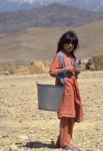 A girl carries a metal pail along the rocky terrain of the UNICEF-assisted Sarshahi camp for displaced persons near the city of Jalalabad in the eastern province of Nangarhar. Because the camp is located on dry rocky land, water must be brought in by truck or collected from a nearby canal and then treated with chlorine to make it safe for drinking. In 1994 in Afghanistan, civil conflict -- now in its 15th year -- has destroyed the country's economy and infrastructure. Already one of the world's poorest countries before the war, the situation has become dismal. Some one million people are dead and twice that number are injured or disabled. Over 500,000 women have been widowed. A third of the population has become refugees and some two million people have been internally displaced. UNICEF-assisted programmes focus on the immediate needs of the country's most vulnerable, including displaced populations and children in especially difficult circumstances, by providing basic health care, sanitation, safe water and vaccinations.