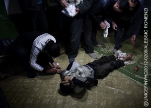 In late January, a boy receives first aid after being shot in the foot by a sniper, in a town affected by the conflict. In January and Feuary 2012 in Syria, children found themselves in the midst of a growing conflict between rebel and government forces. By mid-March, violence had claimed the lives of more than 500 children and 244 women. By late March, the year-long conflict had killed 9,000 people and wounded many others. An estimated 1.7 million people have been affected by the violence, which has extended into at least half of the countrys 14 governorates. Education and health services have also been disrupted. Some 150,000200,000 people have been internally displaced. An estimated 30,000 refugees half of them children have fled to Turkey, Lebanon and Jordan. While most have registered with the United Nations High Commissioner for Refugees (UNHCR), others have not, fearing possible retaliation against them or family members remaining in Syria. Many refugees in Lebanon and Jordan are being hosted by local families, who also require assistance. UNICEF is participating in an inter-agency assessment of needs in conflict-affected parts of Syria and has requested US$7.4 million to with governments, UNHCR and local and international NGOs address the needs of an anticipated total of 40,000 refugee children, including those staying with host families, in Jordan, Lebanon and Turkey, over the next six months. Support includes psychosocial assistance for children traumatized by the conflict to which they have been subjected or borne witness.