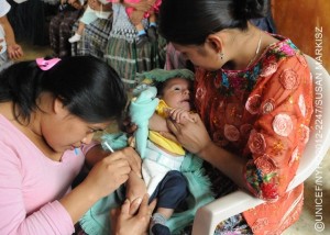 (Right) Alba Flor Bol, an indigenous Mayan woman, holds her 3-month-old daughter, Esteyner Leandrinho Chen, as health worker Lourdes Rodriguez administers a pentavalent vaccination, at a health centre in the community of Corosal in Cobán Municipality, in Alta Verapaz Department. The pentavalent vaccine protects against five common diseases: diphtheria, tetanus, pertussis (whooping cough), hepatitis B and Haemophilus influenza type b (also called Hib, a cause of pneumonia and meningitis). The centre, which is open once a month, serves a population of 1,000, and is run by the Ministry of Health with support from UNICEF. Volunteer health workers provide routine health care and immunizations for pregnant women and children under 5 in five surrounding communities. [#3 IN SEQUENCE OF THREE] In November 2012 in Guatemala, the Government and other partners are continuing to assure sustained routine immunization of children  now reaching 92 per cent of all infants  against a range of vaccine-preventable diseases. The countrys last endemic case of measles was in 1997. In the entire Americas Region (covering North, Central and South America), the last endemic measles case was in 2002 and the last endemic case of rubella was in 2009  part of global efforts to eradicate these diseases. Worldwide, measles remains a leading cause of death among young children: In 2010, an estimated 139,300 people  mainly children under the age of 5  died from the disease. Nevertheless, these deaths decreased by 71 per cent from 2001 to 2011, thanks in part to the Measles & Rubella Initiative, a global partnership led by the American Red Cross, the United Nations Foundation, the United States Centers for Disease Control and Prevention (CDC), WHO and UNICEF. In Guatemala, despite this success, significant other challenges for children remain, much of it related to poverty levels that affect more than half of all children and adolescents. Poverty also contributes to chronic malnutrition affecting half of all under-5 children (with higher rates among indigenous populations); an average national education level of under six years of primary school (under three years for the rural poor); and high, though decreasing, rates of violence. Guatemala is also one of the worlds most vulnerable countries to climate change, suffering a major climate-related emergency every year since 2008. On the positive side, birth registration is improving, with more than 95 per cent of newborns now being registered. UNICEF is working with the Government and other partners to sustain achievements in health, address the high levels of malnutrition, strengthen responses to crimes against children and increase protection services for children throughout public services.