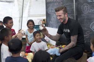 [ALL D.BECKHAM IMAGES ARE RESTRICTED. ALL UNICEF USE MUST BE CLEARED BY chloee@unicef.org.uk OR louiseo@unicef.org.uk] On 14 February 2014 in the Philippines, UNICEF Goodwill Ambassador David Beckham and children play with puppets at a UNICEF-supported tented school in Tanauan  one of the areas hardest hit by Typhoon Haiyan. As a UNICEF Goodwill Ambassador, seeing how children are being given a sense of normality amidst the rubble of their communities has been amazing, he said. I want to show people around the world how their generous donations have had an enormous impact on children and their families and how thankful people here are for their kindness. Mr. Beckhams T-shirt bears the UNICEF logo.