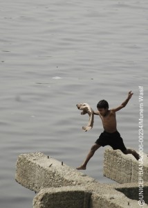 A boy trips off the edge of a boat in Buriganga River near Sadarghat Ferry Terminal in Old Dhaka. It is common for children to drown due to unforeseen accidents.
