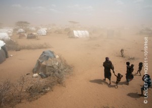 On 9 July, a woman and several children walk through a dust storm to their tent, in an area for new arrivals in the Dagahaley refugee camp in North Eastern Province, near the Kenya-Somalia border. The camp is among three that comprise the Dadaab camps, located near the town of Dadaab in Garissa District.  On 26 August 2011, the crisis in the Horn of Africa  affecting primarily Kenya, Somalia, Ethiopia and Djibouti  continues, with a worsening drought, rising food prices and ongoing conflict in Somalia. Some 12.4 million people are threatened by the regions worst drought in 60 years. Hundreds of thousands of children are at imminent risk of dying, and over a million more are threatened by malnutrition and disease. In Kenya, 1.7 million children have been affected by the drought, including 220,000 Somali refugee children in the north-eastern town of Dadaab. UNICEF, together with the Government, United Nations, NGO and community partners, is supporting a range of interventions and essential services, especially for the displaced and for refugees, including feeding programmes, immunization campaigns, health outreach, and access to safe water and to improve sanitation. A joint United Nations appeal for humanitarian assistance for the region requires US $2.4 billion, of which 58 per cent has been received to date. A majority of UNICEFs portion of the appeal has been funded.