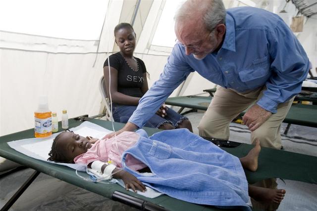 UNICEF Executive Director Anthony Lake visits a girl receiving intravenous fluids for cholera, at the UNICEF-assisted GHESKIO cholera treatment centre in the impoverished Cité lEternel neighbourhood of Port-au-Prince, the capital. Intravenous fluids are administered to remedy the dangerous levels of dehydration that accompany the disease.

On 15 December 2010, UNICEF Executive Director Anthony Lake visited Haiti to support accelerated mobilizations by all United Nations and other partner organizations to prevent the further spread of cholera and to ensure timely treatment for all those affected. Cholera is a deadly bacterial infection that is spread through contaminated food and water. The epidemic has hospitalized 46,749 and killed 2,193, and the number of cases and deaths continues to rise. Mr. Lake visited cholera treatment centres in Port-au-Prince, the capital, and met with religious leaders and partner and media representatives. He also met with His Eminence Bishop Pierre-Andre Dumas, who is coordinating support for the mobilization against cholera among religious groups. Even before the 12 January earthquake, which has left 1.3 million people still displaced, Haitis access to sanitation was among the worst in the world. Post-quake recovery efforts have made significant progress in providing safe water and sanitation, but communicable diseases remain a threat. UNICEF is working with the Government and other partners to scale up cholera treatment facilities throughout the country and to disseminate cholera prevention information, as well as providing medical teams, water purification supplies, antibiotics, oral rehydration salts (ORS) and therapeutic foods. Haitis sanitation agency DINEPA (Direction Nationale de l'Eau Potable et de l'Assainissement) is also distributing chlorine tablets and safe water, and is testing water sources for contamination. On 12 November, UNICEF joined other United Nations agencies and partners to issue a new appeal for US $164 million  of which UNICEFs portion is US $25.2 million  to respond to the cholera emergency. Sixty per cent of UNICEFs portion of the appeal has been received.