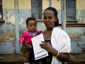 A happy mother displays her child's short birth certificate generated by Mobile Vital Records System (Mobile VRS), at Mulago hospital. At the hospital, birth registration is done using Mobile Vital Records System (Mobile VRS) an innovative technology supported by UNICEF to improve birth registration in Uganda. This was part of the activities during the Uganda Pan African Study Tour Conference under the theme, Breaking with broken systems . The purpose of Uganda Pan-African Study Tour, is to enable government counterparts from countries implementing the above project and members of the Africa Programme on Accelerated Improvement of Civil Registration and Vital Statistics (APAI-CRVS) Core Group to share and learn from each otherÕs innovations in improving national civil registration and vital statistics.