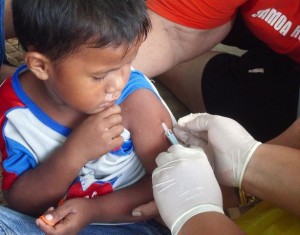 A boy receives a measles vaccination at a temporary clinic in Lalomanu, a village on the eastern coast of Upolu, one of Samoas two main islands. The measles vaccination campaign aims to reach 32,000 children, between the ages of six months and five years, throughout the country. UNICEF is providing essential equipment for the campaign, including vaccines, Vitamin A, syringes and cold-chain equipment. The World Health Organization is providing technical and logistical support. In October 2009 in Samoa, some 3,200 people remain displaced by a tsunami that killed over 140 people on 29 September. The tsunami was triggered by an 8.3-magnitude earthquake on the ocean floor approximately 190 kilometres from Apia, the capital. Coastal villages on Upolu, one of the countrys two main islands, and the small islet of Manono experienced extensive damage. Schools and houses were destroyed, and 10 per cent of subsistence agricultural production was lost due to damaged livestock, gardens and equipment. The destruction leaves affected communities, most of which were already impoverished, increasingly vulnerable. Of the countrys 88,000 children, an estimated 9,000 are affected by the tsunami, including 2,000 who are displaced. Many of the displaced are living in inland camps, where they face increased risk of disease outbreaks. The displacement has exacerbated existing problems with water safety; even under normal circumstances, 12 per cent of the countrys 187,000 people lack access to an improved water source. UNICEF is responding by providing safe drinking water, rehydration salts, soap, hygiene kits, vaccines and other essential supplies to the displaced.