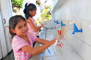 On 3 February, (foreground) Grade 2 student Venus Mueva, 8, washes her hands with soap and water at a new hand-washing facility after using the latrine, at Santo Niño Elementary School in the town of Tanauan  one of the areas hardest hit by Super Typhoon Haiyan  in Leyte Province, Eastern Visayas Region. Her school, which reopened on 8 January, was badly damaged by the storm. Classes are now being held in tents and makeshift or repaired classrooms. UNICEF has provided tents, educational supplies, latrines and hand-washing facilities at the school and is also supporting teacher training. Many of the students lost family members and other relatives during the disaster, and most have lost their homes and belongings. Venuss 4-year-old sister, Viana, was swept away during the storm. Her home was also destroyed. She and her parents now live in a temporary shelter located just a few metres from the school. In early February 2014 in the Philippines, Government-led relief operations continue following the destruction caused by Typhoon Haiyan, which hit the country on 8 November. The typhoon, known locally as Yolanda, was one of the strongest to ever to make landfall. More than 6,200 people have been killed in the disaster and 1,785 are missing. The storm also destroyed homes, schools, hospitals, roads, communications and other basic infrastructure, and damaged power and water supply systems. An estimated 14.1 million people, including more than 5.9 million children, have been affected; and, three months after the massive storm, 4.1 million people, including over 1.7 million children, remain displaced. Many of the displaced are still living in damaged or makeshift dwellings, temporary tents and evacuation centres. In response to the emergency, UNICEF has delivered 100 tons of relief supplies for typhoon-affected communities, including emergency health kits (each containing medicine, medical supplies and basic medical equipment to meet the needs of 10,000 displace