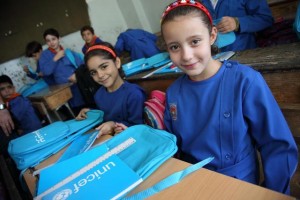 On 16 September 2014 in the Syrian Arab Republic, girls in Grade 3 sit with the school bags and stationery supplies they have just received at their school in central Damascus, the capital. The bags and supplies bear the UNICEF logo. The countrys schools reopened on 14 September. To encourage children to return to learning, UNICEF launched a national media campaign to raise public awareness about the importance of education and convey key information on school registration. The campaigns messages were disseminated through such methods as a short radio programme, mobile Short Message Service (SMS), billboards, posters and flyers. UNICEF and partners also distributed school bags with essential stationery supplies to 1 million conflict-affected primary-school-aged children in nearly 300 sub-districts in all 14 governorates.