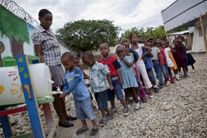 A teacher watches as a boy, at the head of a queue of small children, washes his hands with soap and chlorine-treated water at a hand-washing station at Ecole Joyeux Lutins in Port-au-Prince, the capital. A tent classroom is visible behind them. The school, with support from UNICEF, was rebuilt as a semi-permanent structure after the original building was destroyed in the earthquake. Nearly 130 quake-proof, semi-permanent schools (serving more than 30,000 children) have been built in the capital with UNICEF assistance. From 7 to 8 June 2011, international golf star Rory McIlroy, in his first visit as a UNICEF National Ambassador for Ireland, travelled to Haiti to draw attention to the ongoing needs of children and families as a result the devastating January 2010 earthquake, and to view UNICEF-supported programmes. The quake killed 220,000 people and destroyed vital infrastructure; nearly 18 months after the disaster, over 810,000 people remain displaced. The situation is exacerbated by a cholera outeak that has killed more than 5,000 people and sickened over 291,700. Mr. McIlroy met with quake-affected children and families and visited UNICEF-supported programme sites in and around Port-au-Prince, the capital. He visited a rebuilt school, where he participated in a hygiene education session on the importance of proper hand-washing to prevent the spread of cholera; a health and nutrition clinic providing cholera treatment services in addition to information on proper nutrition and feeding, health check-ups and growth-monitoring; and a child-friendly space providing a safe play environment for nearly 200 children. UNICEF supports more than 1,000 cholera prevention and treatment facilities throughout the country, and is rehabilitating water systems in Port-au-Prince and in vulnerable rural areas and distributing cholera prevention supplies in schools. UNICEF is also helping to build child-friendly, earthquake-proof schools; supporting over 350 child-friendly spaces providing safe play areas for more than 94,000 children daily; and is supporting nutrition screenings and other services for children and nutrition training for paediatric staff. A United Nations consolidated appeal for US $915.3 million, launched November 2010 to provide essential humanitarian assistance in the country, remains largely unfunded: Just 24 per cent of the requested funds have been received to date. UNICEFs portion of the appeal is US $124.8 million. Mr. McIlroy was appointed a UNICEF Ambassador in March of this year.