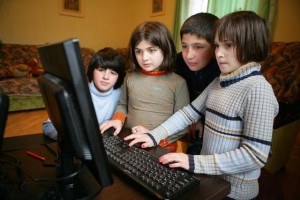 Children use a computer at a small-group home in the south-eastern city of Rustavi. Small-group homes accommodate children who cannot be adopted or reintegrated into their biological families. The homes were established following the closure of a local childrens institution; they are supported by UNICEF and the Georgian NGO Child and Environment. Children in the homes are assigned mother and father caretakers, who create a family-like environment for a small number of children.  In January-February 2010 in Georgia, UNICEF continues to support efforts to improve care and protection for vulnerable children, particularly impoverished and disabled children left without parental care. It is estimated that over a million children in Eastern Europe and the Commonwealth of Independent States are living in institutions, many of them abandoned by families unable to care for them due to poverty or disability. With support from UNICEF and other partners, the Government of Georgia has launched multiple efforts to reduce the number of children living in institutions. Deinstitutionalization efforts include establishing fostering, adoption and community-care alternatives to institutionalization and providing assistance for families in poverty and families with disabled children. Beginning in 1999, the Government enacted child welfare reforms and recruited social workers to support families at risk of placing children into institutions. By 2008, the number of children living in state-operated institutions dropped to 2,600, although others may continue to live in non-state facilities. UNICEF and partners complement the Governments efforts with additional services for vulnerable children, including foster care, small-group homes, day care and education support. Further efforts are required to provide appropriate care to children with disabilities, and to provide economic and other assistance to families in need.