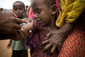 On 2 August, a community health worker vaccinates a child during the UNICEF-supported measles and polio immunization campaign under way in the Ifo refugee camp in North Eastern Province, near the Kenya-Somalia border. The camp for Somalia refugees is among three that comprise the Dadaab camps, located near the town of Dadaab in Garissa District. By 2 August 2011, the crisis in the Horn of Africa affecting primarily Kenya, Somalia, Ethiopia and Djibouti continues, with a worsening drought, rising food prices and an ongoing conflict in Somalia. More than 12 million people are threatened by the regions worst drought in 60 years. Somalia faces one of the worlds most severe food security crises as it continues to endure an extended humanitarian emergency, with tens of thousands fleeing into Kenya and Ethiopia. More than 10,000 Somalis a week are now arriving in the Dadaab camps in north-eastern Kenya, where aid partners are struggling to meet the needs of 400,000 people. In drought-affected areas of Kenya, Somalia, Ethiopia and Djibouti, some 500,000 severely malnourished children are at imminent risk of dying, while a further 1.6 million moderately malnourished children and the wider-affected population are at high risk of disease. In northern Kenya, more than 25 per cent of children suffer from global acute malnutrition. UNICEF, together with Governments, UN, NGO and community partners, is supporting a range of interventions and essential services, especially for the displaced and for refugees, including feeding programmes, immunization mass vaccination campaigns are now underway in drought-affected parts of Kenya and Somalia and other health outreach, as well as access to safe water and to improve sanitation. In Kenya, the Ministry of Health, UNICEF and the World Health Organization (WHO) have reached 290,000 children with polio and measles vaccinations in refugee host communities near the Dadaab camps. UNICEF is providing the vaccines, as well as deworming tablets and vitamin A (to boost childrens immunity). A similar campaign is now under way to immunize children in the Dadaab camps. A joint United Nations appeal for humanitarian assistance for the region requires US$2.5 billion, less than half of which has been committed.