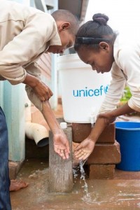 On 25 February, (left-right) students Elyse Christian Mianvontsoa and Tiavina Rasoaremalala, both 12, wash their hands at a UNICEF-provided covered bucket with a faucet after using the latrine, at Lohanosy Primary School in Lohanosy Village in Analamanga Region. Many families, including theirs, are struggling to both provide food and pay their childrens school fees. I know that my parents have difficulties making money, and its a big challenge for me, so I try harder at school. I want to be a doctor when I grow up, Elyse Christian said. I like studying science and history at school. My dream is to finish school and become a teacher, Tiavina said. For me, its very difficult to follow [along] at school because we dont eat enough at home, and I often have a stomach ache. If my parents dont work, we dont have enough food. Tiavina is one of nine children in her family. Her parents grow rice for food, and her mother also makes and sells rope, to buy for food and clothing and to pay school fees. UNICEF supported construction of classrooms, the water and sanitation facilities and a sports field, as well as promotes good hygiene practices at the model primary school, which is built on land donated by the community, and with support from the Ministry of Education and the private sector. In February 2015 in Madagascar, children and families continue to face considerable challenges and constraints as the island nation slowly emerges from a protracted and debilitating political crisis and the ensuing economic decline. The country remains one of the worlds poorest: 91 per cent of the population live on less than US $2.00 a day, and many of the poorest are children  who have been hardest hit in the crisis and live in extreme poverty. The crisis also resulted in a decrease in public investment in the social sectors, weakening further the delivery of basic social services, as well as access to, and use of, these vital services. The health