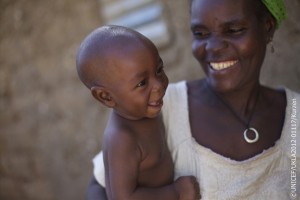Niger, November 2012. Haouaou Abdou, 52, mother of 6 children is smiling at her youngest son Issiakou, 8 months, in the village of Mazadou Abdou.   By Jessica Mony  In 2011, droughts across the Sahel plunged millions of families into a food crisis. A year after UNICEF and partners emergency response began, we ask ourselves how can we stop this vulnerability and persistent cycle of suffering? A poor, rural Nigerien village 600 people may hold the answer. Here, despite every familys struggle during the drought, no child suffered malnutrition in 2012.  Just three years ago it was rare for a week to go by without a child dying from combinations of malnutrition, diarrhoea and malaria in Mazadou Abdou village. During the frequent droughts, at times this would rise to two or three. No family was spared the pain of loss and mourning. Haouoau and Loli Abdou are just one set of parents that faced this tragedy. Loli holds up three fingers and lists that in 2000, 2002 and then again in 2004 they lost three children to malaria. Looking solemnly at their healthy 8 month baby boy Issiakou, it is clear the scars will likely never heal for this family. Sadly, their situation is not unique in this or any other village across the Sahel.  Fortunately, in 2008 a simple UNICEF programme of family practices helped change all of this. The practices are simple and include exclusive breastfeeding for the first six months of life; complementary feeding for children after six months; proper hand-washing techniques; treatment of diarrhoea; knowledge of how to seek medical care; immunisation; using mosquito nets to prevent malaria; promotion of delayed pregnancies and girls education. The results of adhering to these practices for the children of Mazadou Abdou have been significant. Moutari Louali, a community volunteer who is helping to implement the programme explains the impact. Before the programme started, around four to five children would die every month from malaria, diarrhoea and other diseases. Now, during the whole of this year only three children died, and this was because of miscarriages. From the chief through to parents and children themselves, the whole village is determined that no child should die from preventable diseases. Haouaou is clearly proud of the result In this village we didnt have any malnutrition because we take care of our children. I am very happy about how healthy our children are.   At the heart of the programme are volunteers like Moutari who, along with two other volunteers selected by the community, ensure that every family implements the practices and monitors progress. Every week the group visit up to five families to run information sessions. Today, Moutari is visiting Hoauoaus household. Starting with an update on the health of their children, Moutari then calls a mother and her child forward to demonstrate a particular practice. Today its the use of mosquito nets and hand washing. Everyone here comes to listen and learn. Haouaou points at two of her daughters who were born before and after the programme started and she learnt about the benefits of exclusive breastfeeding. Look you can see this one is much stronger. Whilst drought, hunger and vulnerability are an ongoing reality for these families, their efforts to implement the programme are the key to ensuring their children not only survive, but are resilient through times of drought and extreme hardship.   Issa Iahim the 63 year old chief of Mazadou Abdou describes the precarious situation many families across the Sahel live in. In this village our life is based around farming. The difficulty of this life is that if the rainy season doesnt give a good harvest, life becomes extremely difficult for us. For now the health of their children is safe, but the challenges ahead for the village are immense. A community run cereal bank will help tide them over for a while, but after this the only other option for many families is for husbands and fathers to head to Nigeria to search for work. Haouaou has thirty bowls of millet to feed her family until the harvest a year away. It will only last a month. She holds out the bowl and laughs nervously. What can we do?    Whilst Mazadou Abdous families continue to walk a tightrope of vulnerability, their newfound knowledge will keep their children alive and healthy. It is not the whole solution, but it provides the hope of a future for their most precious resource, their children. The Chief is thankful for how far they have come. We are very proud and happy for what we have done here. We thank God, we thank the people who taught us these practices, but he is also conscious of the toll of chronic hunger on the future of this community; If a man is hungry he cannot hear, he cannot learn anything.  The impact of the emergency response across the Sahel can be seen in the short term in the lives saved and the malnutrition prevented. For vulnerable families like Haouaous though, building resilience and food security will be key to long term change. This village has demonstrated the success of community driven initiatives to improve childrens health, but more support is needed to ensure communities across the Sahel are able to withstand crises. Haouaou tries not to think about what might happen a year from now; Nobody can forsee the future. Even if we wait and hope for the best, anything can happen at any moment.  UK Natcom - for local copies of the files: Y:Key-initiativesIFSahel-Stories-2012Niger