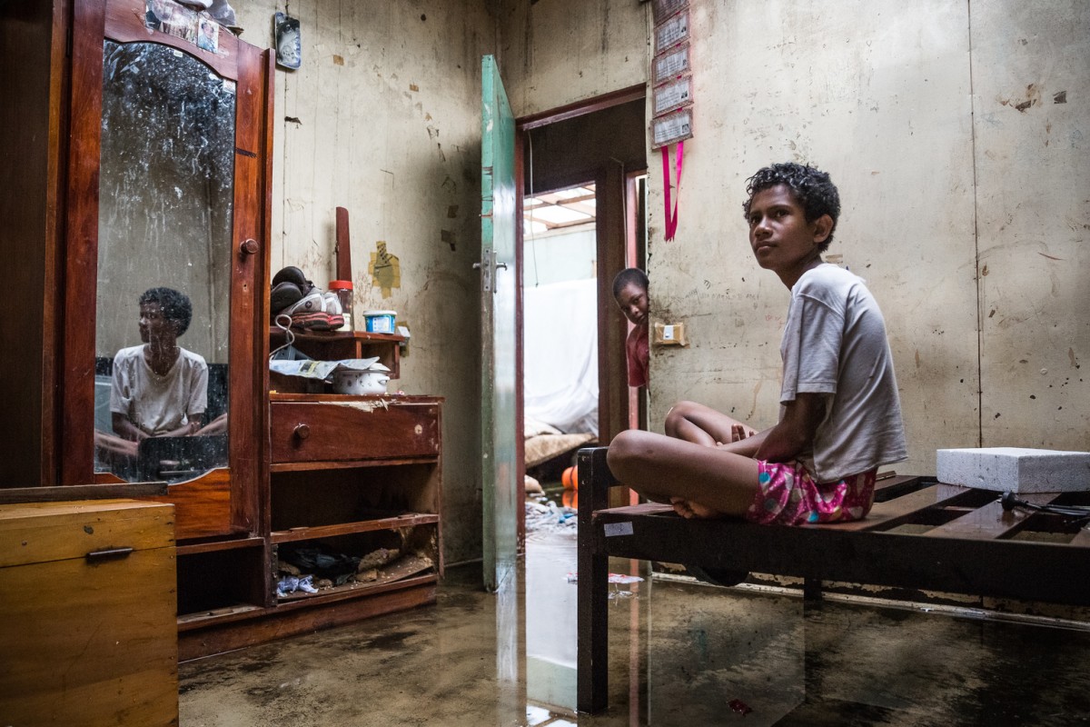 On 24 February 2016, Makereta Nasiki, 13, sits in her room, showing damage caused by Tropical Cyclone Winston in the town of Ba on Viti Levu Island of Fiji. 

Makerata says "It was the most terrifying night of my life. Our family had to move to three different places during the storm at night".

Category 5 Tropical Cyclone Winston made landfall in Fiji on Saturday 20 February 2016, continuing its path of destruction into Sunday 21 February. A state of natural disaster and a nationwide curfew had been declared by the Government of Fiji earlier in the evening. In the wake of Cyclone Winston, UNICEF's main concern is for children, pregnant women and breastfeeding mothers across Fiji. Little is yet known about the status of communities living on the outer islands of Fiji that were directly under the eye of Tropical Cyclone Winston- as communications remain down for many. The Fijian Government is rapidly working to assess the overall situation in order to pinpoint the critical needs. The Fijian Government has declared a state of natural disaster for the next 30 days and has initiated the clean-up process by clearing the huge amounts of debris scattered everywhere. UNICEF staff members are standing by to assist as required.