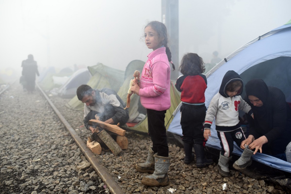 On 8 March 2016, a girl in a pink sweater holds her doll outside a row of makeshift tents, which have been pitched up on the train tracks leading into the former Yugoslav Republic of Macedonia.In March 2016, despite the border restrictions in the Balkans, the influx of refugees and migrants to Idomeni has continued, with reports indicating that up to 14,000 people are waiting to cross the border from Greece to the former Yugoslav Republic of Macedonia , with as many as 60 per cent women and children. In the chaos and confusion, children have been forced to sleep outside in the open in squalid conditions, lacking access to basic services, such as showers and food.  The current dire situation unfolding on the borders of Greece and the former Yugoslav Republic of Macedonia, remains unacceptable for children who are now in the majority of those on the Idomeni border in northern Greece. With regard to the outcome of the EU Summit with Turkey on 8 March 2016, UNICEF reiterates that in the implementation of such decisions the fundamental humanitarian principle of do no harm must guide authorities across Europe, the Balkans and Turkey at every step when it comes to the care of refugee and migrant children. In the immediate term, the current dire situation unfolding on the borders of Greece and the Former Yugoslav Republic of Macedonia, remains unacceptable for children who are now in the majority of those on the Idomeni border in northern Greece. Children have already endured so much - fleeing war and conflict, and a dangerous crossing.  It is yet another blow that they are now forced to sleep in the open, with no access to basic services, unsure whether they can go forward or be forced back. Children stranded are at greater risk to smugglers and traffickers and their rights must be prioritized.  UNICEF stands ready to support the Government of Greece to find immediate solutions for refugee and migrant children.