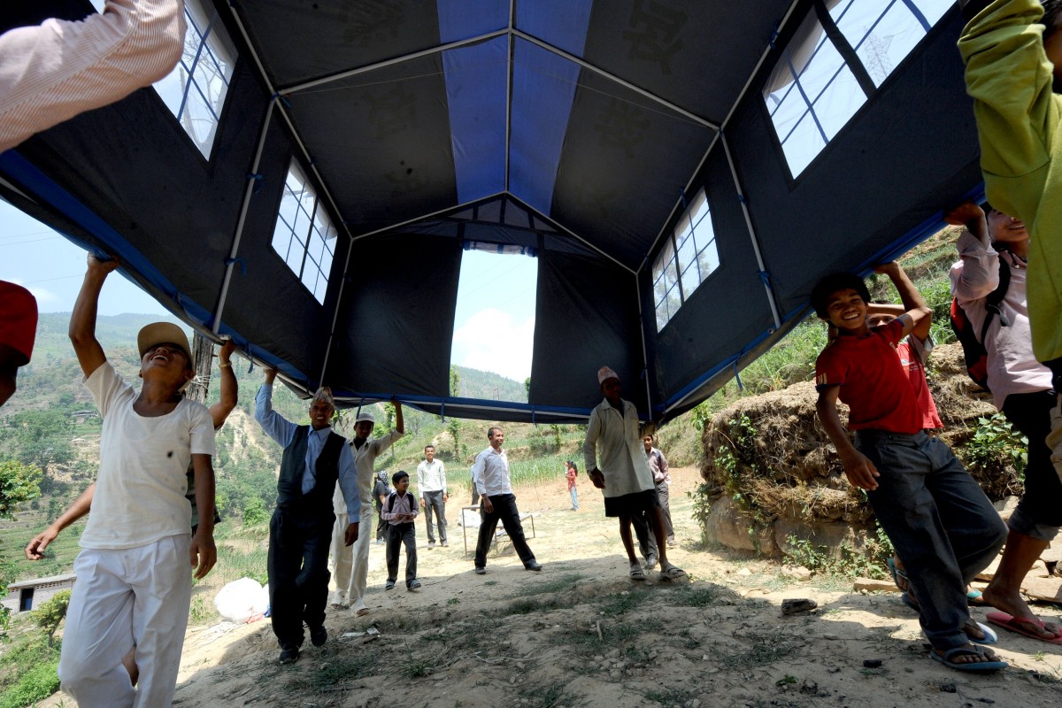 On 31 May 2015, Ramesh Shrestha helps his teachers and others to place the makeshift school tent in appropriate place to resume classes in Shree Balephi Secondary School in Balephi, Sindhupalchowk, one of the hardest-hit district by the earthquake. After five week hiatus following the earthquakes of 25 April and 12 May, teachers, members of school management committee, students and parents worked together to set up the makeshift school.

First Day of School Package - Photos from Sindhupalchowk - 31 May 2015