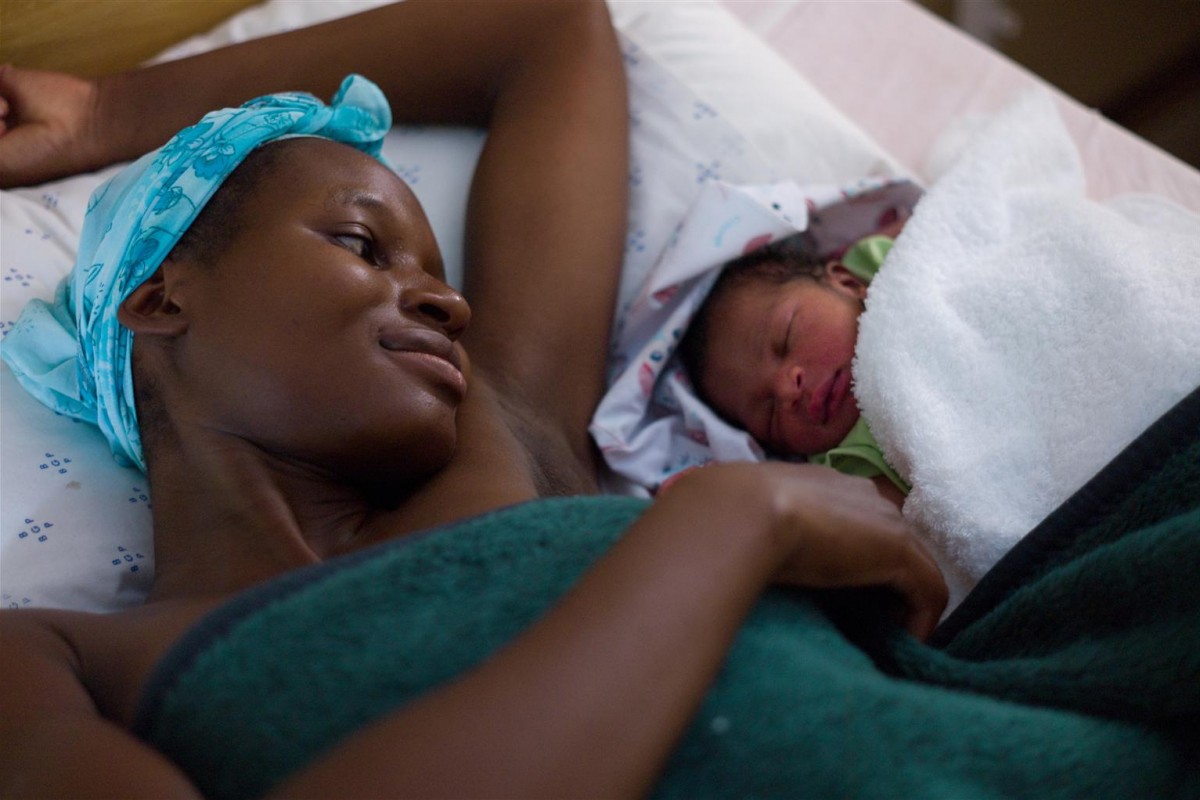 A mother with her newborn baby recovers in a postnatal ward at the Shakawe clinic in the village of Shakawe in Botswana on November 29, 2010.