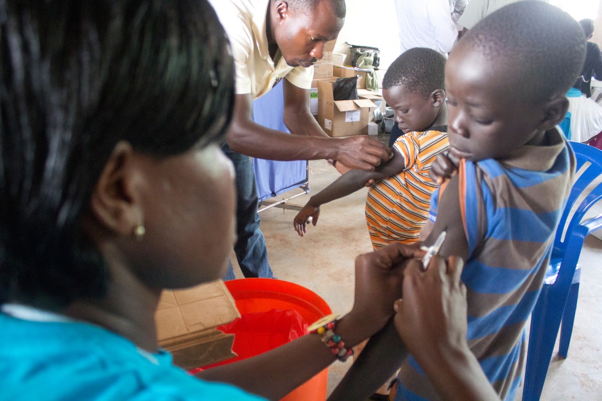 Children being immunised at Elegu reception centre July 27, 2016.  Hundreds of displaced South Sudanese are received, registered and resettled everyday since the conflict in South Sudan worsened early July 2016.. Thousands of refugees that have been flocking the Uganda-South boarder since the escalation of hostilities, have been received at the reception centre daily and undergo health and nutrition check ups before being resettled in various refugee settlements in Adjumani district. Most of the refugees were resettled in Pagrinya, Nyumanzi and Maaji III refugee settlements in Adjumani district. UNICEF, the Ugandan government and other Aid agencies have been greatly involved in these activities.