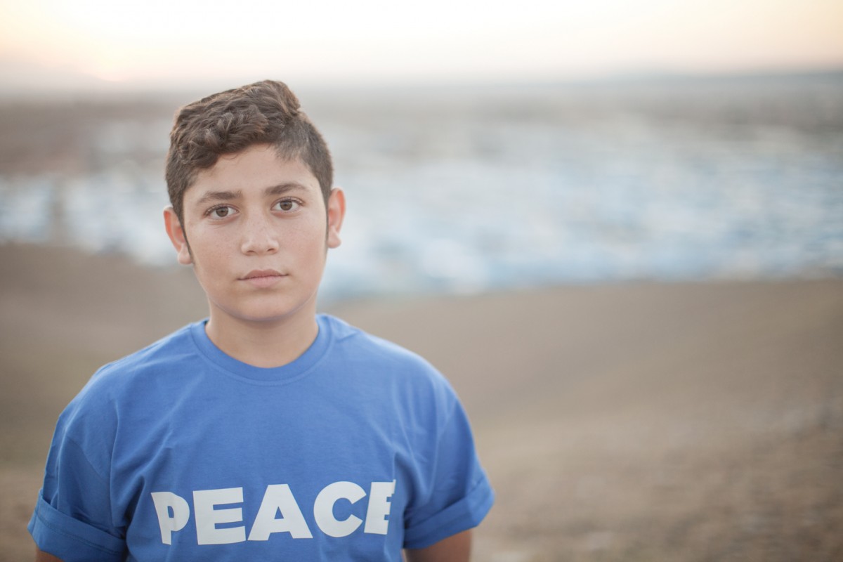 On 4 November 2015 in Iraq, Ahmad, 14, lives in the in the Kawergosk camp for Syrian refugees, just west of Erbil, the capital of Kurdistan Region.

14 March 2016 - An estimated 3.7 million Syrian children  1 in 3 of all Syrian children - have been born since the conflict began five years ago, their lives shaped by violence, fear and displacement, according to a UNICEF report. This figure includes 306,000 children born as refugees since 2011. In total, UNICEF estimates that some 8.4 million children - more than 80 per cent of Syrias child population - are now affected by the conflict, either inside the country or as refugees in neighbouring countries. In Syria, violence has become commonplace, reaching homes, schools, hospitals, clinics, parks, playgrounds and places of worship, said Dr. Peter Salama, UNICEFs Regional Director for the Middle East and North Africa. Nearly 7 million children live in poverty, making their childhood one of loss and deprivation.
 
According to No Place for Children, UNICEF verified nearly 1,500 grave violations against children in 2015. More than 60 per cent of these violations were instances of killing and maiming as a result of explosive weapons used in populated areas. More than one-third of these children were killed while in school or on their way to or from school. In Syrias neighbouring countries, the number of refugees is nearly 10 times higher today than in 2012. Half of all refugees are children. More than 15,000 unaccompanied and separated children have crossed Syrias borders. Five years into the war, millions of children have grown up too fast and way ahead of their time, Salama said. As the war continues, children are fighting an adult war, they are continuing to drop out of school, and many are forced into labour, while girls are marrying early.
 
In the earlier years of the conflict, most of the children recruited by armed forces and groups were boys between 15 and 17 years ol
