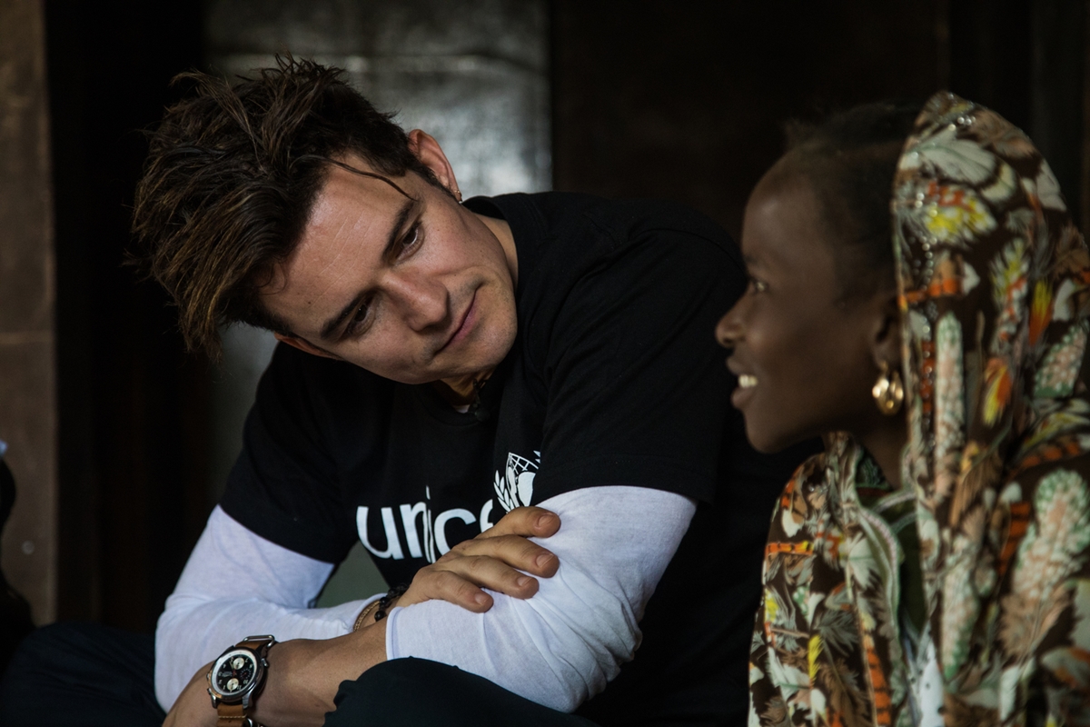 UNICEF Goodwill Ambassador Orlando Bloom (left) smiles as he speaks with twelve-year-old Eta Ibrahim at her family's home, where she lives with her father - the village chief, and her four siblings, in Bosso, Niger, Sunday 19 February 2017. Eta remembers the attacks vividly. It was the 6th of February 2015 around 7AM when she first heard the shootings. Her father and older brother went hiding in the bush while she waited in fear. Around 8AM, Boko Haram forced the door of her home and lined them up in the courtyard, looking for her father and threatening to kill everyone if they didnt give him up. They eventually left with captives. She cried until exhaustion and fled by foot with her family the next day to Yébi where they had relatives. She remembers the thirst and the hunger of their journey but when she finally received some food, she couldnt eat. She couldnt sleep for months because of the nightmares where she would see Boko Haram coming after her to kill her. She fled to Diffa where she resumed school but she didnt know anyone there and felt lonely. Her mother became ill while they were displaced and eventually died. In October 2016, she finally went back to Bosso where she feels much better. She has resumed her education, starting 7th grade with her friends. She now sleeps better. One day, she dreams of becoming a doctor to help the sick and wounded.

In late February 2017, UNICEF Goodwill Ambassador Orlando Bloom travelled to Diffa, south-east Niger, to highlight the ongoing humanitarian crisis in West Africas Lake Chad Basin (Niger, Nigeria, Chad, Cameroon). Boko Haram violence has caused huge population displacements, leaving hundreds of thousands of children in a critical situation, out of education and at risk of malnutrition. Across the four countries, 2.3 million people are now displaced, making this one of the fastest growing displacement crises in Africa. The Diffa region currently hosts over 240,000 internally displaced people, refug