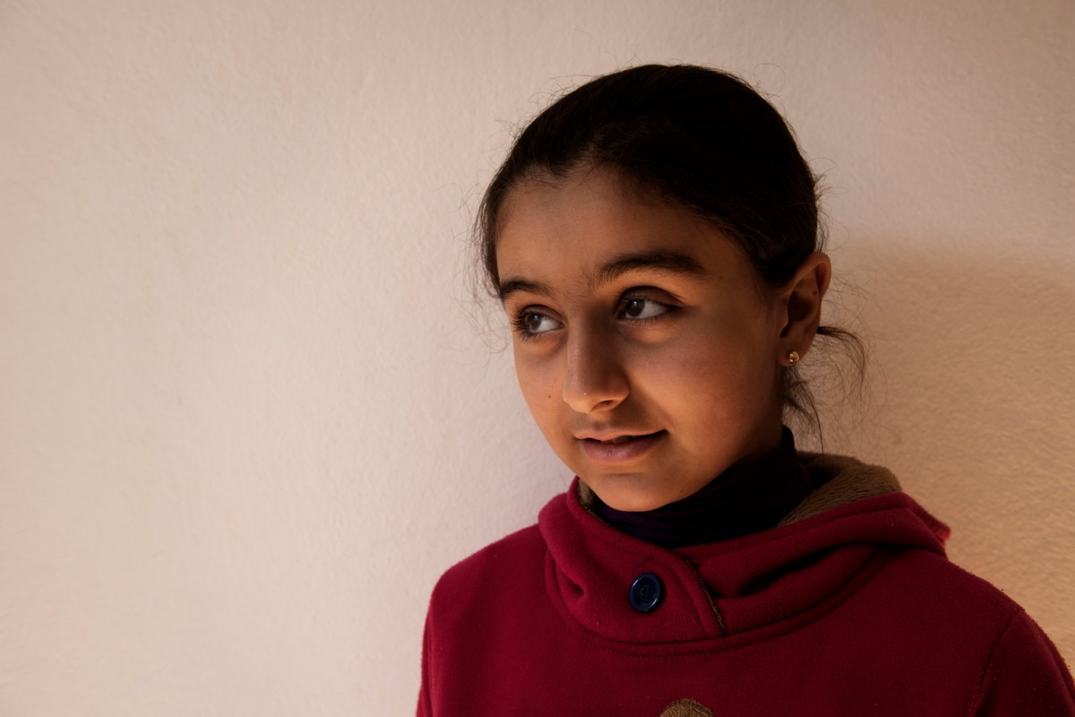 Syrian refugee Sham, 10, sits in the family's apartment in Misrata, Libya, Saturday 28 January 2017. "My dream is become a doctor or a teacher," says Sham, "My only nightmare is the sea, because my brother died in the sea."

Syrian refugee Diia, his wife Fouzieh, ten-year-old daughter Sham and five-year-old son Baial currently live in rural Misrata, Libya. When fighting started in their hometown in Syria, the family sought safety in another part of the country - but aerial bombardments meant the family had little choice but to flee. They took refuge in Benghazi, Libya. In August 2015, the family made an attempt to cross the Mediterranean Sea to Europe. Diia wanted to ensure that his family could live in safety and his children study. They entrusted their lives to smugglers. They made us go out in groups, says Fouzieh recounting the experience in January 2017, first Africans - they loaded them in the back of the boat. When the lower deck was full [] we went up with other Syrians and the ship left in the night. Within ten minutes of leaving the shore, the boat began to list to one side. People in the lower deck screamed with desperation, as the boat filled with water. The smuggler gave us no attention, says Fouzieh, The boat went down and people started to dive. Each one on his own. No one cared for others, everyone thought only for himself. If someone saw a child close to him in tears asking for help, he would not be saved. On that fateful night, Fouziehs eleven-year-old son Talal died. The experience was harder than the war itself, says Diia, The smugglers are not humans [] they abandoned us in the sea. For Talals younger sister Sham, the experience was deeply traumatic my only nightmare is the sea, because my brother died in the sea she says.