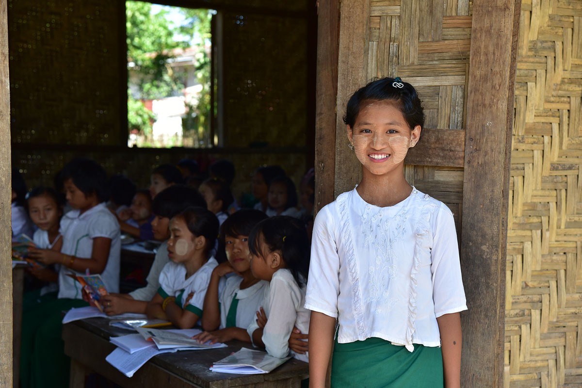 A young school-girl poses for a picture at a state school nearby IDP camps in Myitkyina, Kachin State, Myanmar.