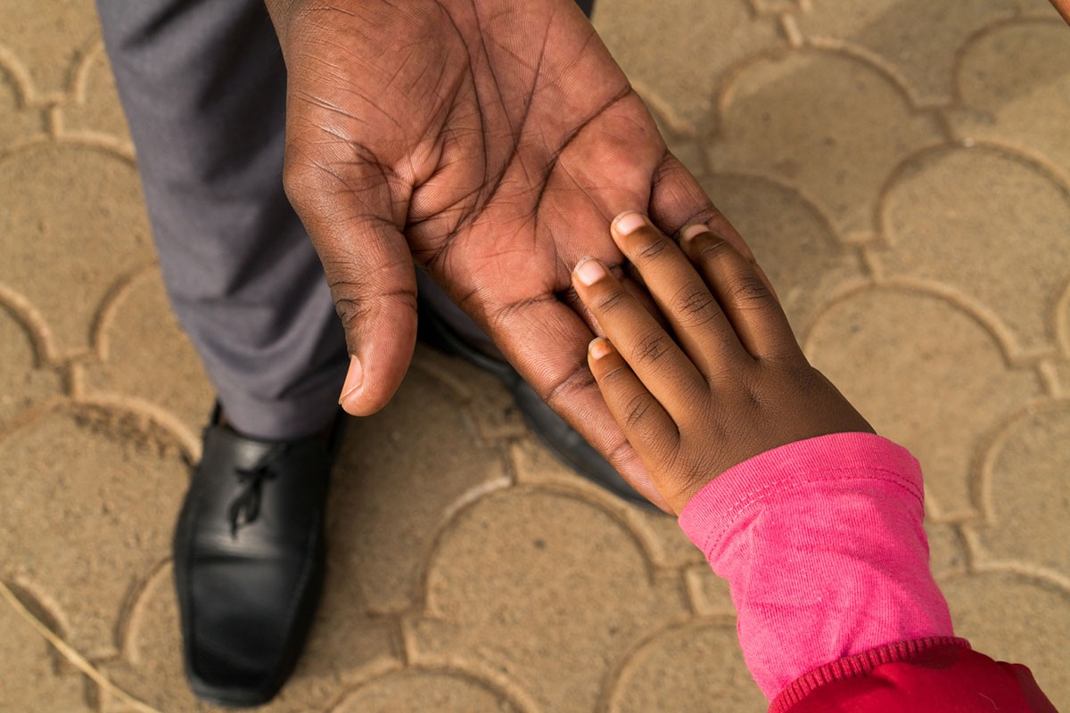 Karen, age 3, holds hands with her father Iddi Badi, age 34, outside of the school building at the Little Rock Early Childhood Development Centre in Kibera, Nairobi, Kenya, May 16, 2017.  

"This is Karen's second year. I love this school, the way they nurture and bring the children up, and the way that she learns to interact and express herself. They don't discriminate against any children here." said Iddi Badi.

The first five years of life have a profound effect on a child future ?on her health, education, wellbeing and financial success as an adult.  When parented with love, nourished and cared for in safe and stimulating environments, children develop the cognitive, emotional and behavioural skills they need to embrace opportunity and bounce back from adversity. They start life with a fair chance to grow, thrive and contribute to their communities and the world. 

But far too many children are denied the right to adequate nutrition, protection and the stimulation that comes from talk, play and responsive attention from caregivers.  These deprivations not only hold back individual children, they launch a cycle of disadvantage and inequity that can continue for generations. 

Recent advances in neuroscience pinpoint the environmental factors that can disrupt development. This neuroscience points to exciting new ways to protect vulnerable children and help them build resilience so they can survive, grow and reach their full potential. Early in life, a child develops cognitive, language and psychosocial skills, a process known as early childhood development (ECD).

Recent discoveries in neuroscience have provided a growing list of details about how a baby brain develops during this time of life. As a result, we know that a baby brain is constructed by a complex interplay of rapid neural connections that begin before birth. In a child first years, these connections occur at a once-in-a lifetime speed of 700 to 1,000 a second.  As the brain-build