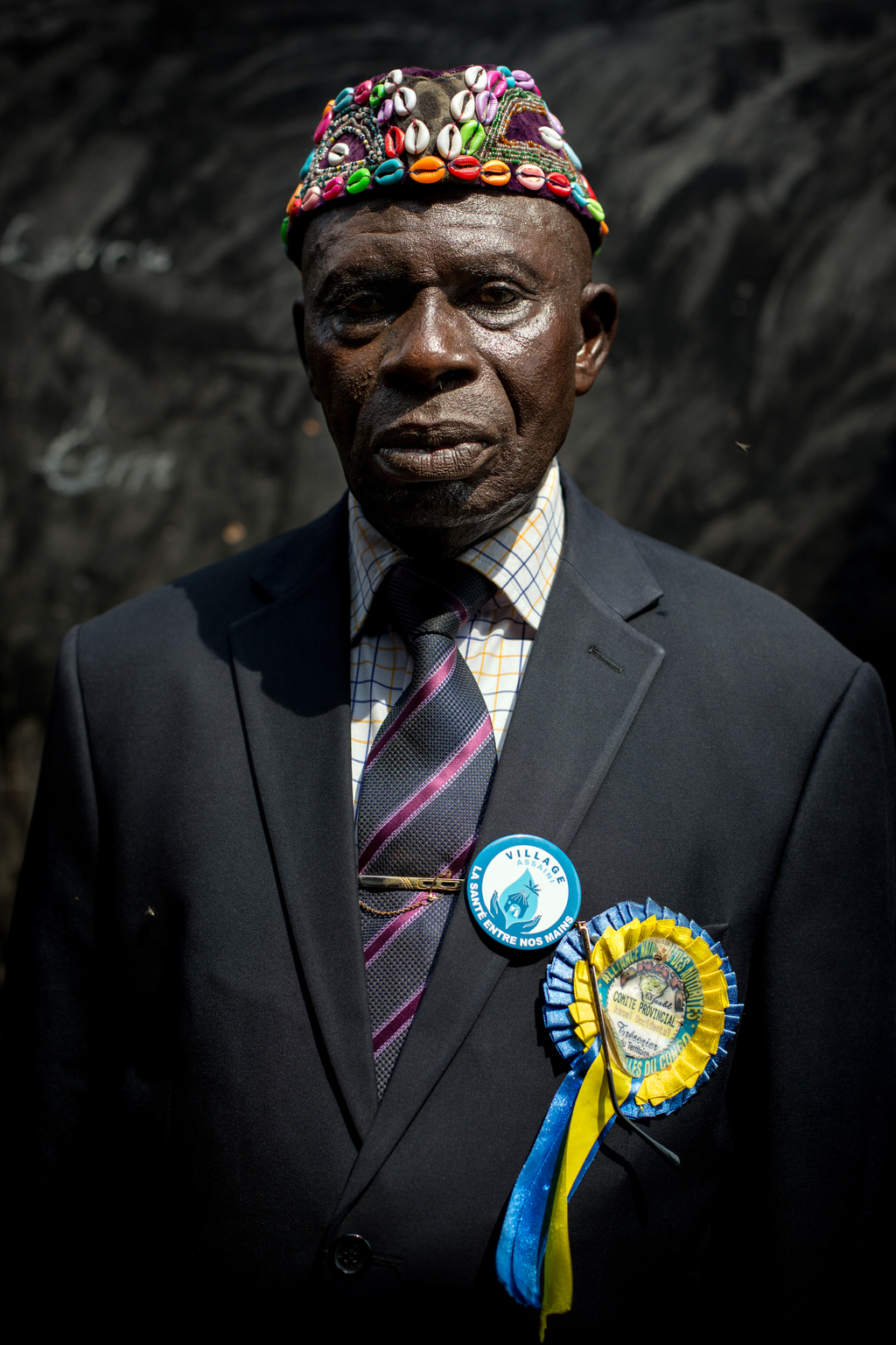 Chief Tshibambula Tshipanba Ntalaja is posing in a classroom at the school of the village of Tshibambula, 16 km southeast of Kananga, capital of the Kasai province, in the Democratic Republic of the Congo. Since November 2016, the village found itself in the midst of the fighting between the militia of the traditional chief Kamuina Nsapu and the Armed Forces of the Democratic Republic of Congo (FARDC). Since June 2016, the village was supported by UNICEF through the