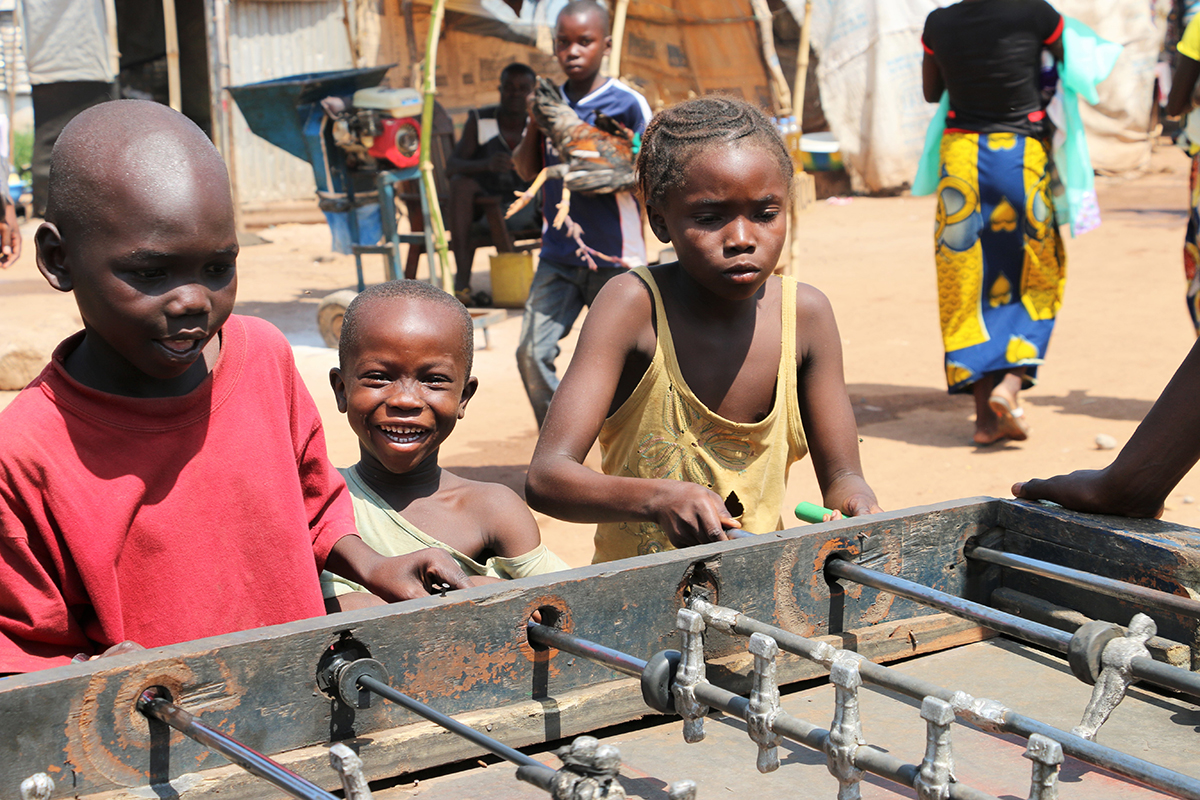 Bangui, Nov 13, 2015: Children play table football in Bangui airport Mpoko camp for internally displaced persons. During the summer of 2015 security had started to improve in town and the site was slowly getting ready to be shut down. A new outburst of violence in Sept and Oct led to new displacements.assistance to cash assistance. It is an empowering and dignified form of support to children and their families, with a positive effect on the local economy and with lower administrative costs.