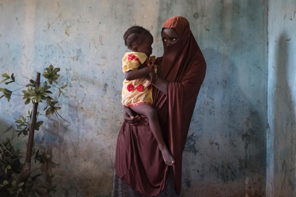 Dada, 15, holds her 18-month-old daughter Husseina where shes live in a host community in Maiduguri, Borno State, northeast Nigeria, Saturday 29 July 2017. Dada was abducted by Boko Haram and became pregnant while in captivity. "There is an area near here where I used to go and they call me Boko Haram wife. Those people don’t know God,” says Dada. “I know she is my daughter, I don’t care why they say, I love her. Since I came back from Boko Haram there has been a lot of suffering, there is not enough to eat.”

“I like to chat with Husseina, I like to play with her,” adds Dada, “I want to put her in school. She needs good food and clothing. I think it is important to show her love and make her smile. I want her to be successful in life.”

As of 15 July, UNICEF and implementing partners in Nigeria have reached a total of 4,306 beneficiaries (3,039 children and 1,267 women) formerly associated with armed forces or armed groups including women and girl survivors of conflict-related sexual violence, with community-based reintegration services and short-term reintegration assistance packages, social cohesion and livelihood support.

UNICEF is providing psychosocial support for children who have been held by Boko Haram and is also working with families and communities to foster the acceptance of children when they return. This includes providing social and economic reintegration support to the children and their families.

The ongoing crisis in the Lake Chad basin is marked by massive violations of children’s rights – evident in the use of children on both sides of the insurgency. Boko Haram, in particular, has been leading a systematic campaign of abduction that has forced thousands of girls and boys into their ranks. Local militias, formed to protect their communities, have played a key role in stemming the  tide of Boko Haram violence, but they too have used children in their operations.

UNICEF estimates that thousands of children are being held