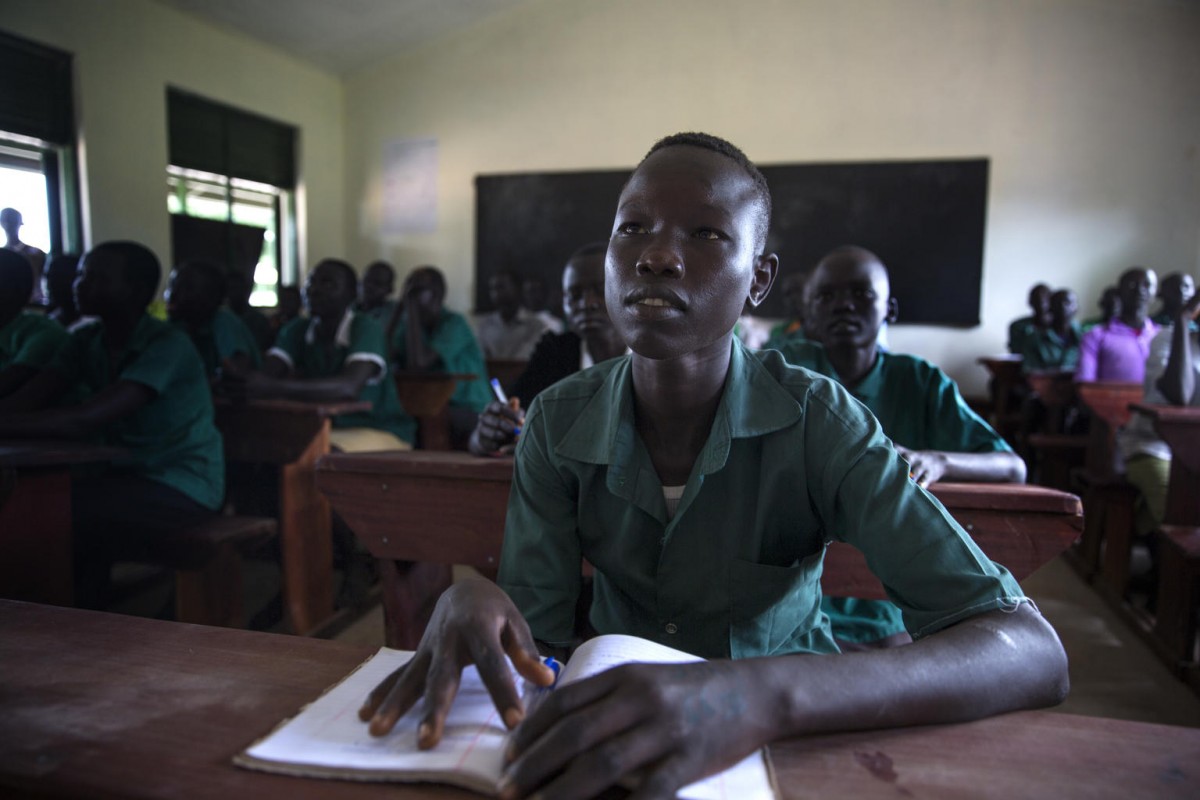 David Sawat Manyang, 16, sits in a classroom of a new school building in Pachong, near Rumbek, South Sudan, Tuesday 8 August 2017. For two years, David was not able to attend classes after clashes between rival youth groups in the region resulted in his school being shut in 2014. It reopened last year after a peace agreement was signed between the groups, though like many schools in South Sudan it was in an extremely dilapidated condition. Before the new school was established, David worked at a cattle farm with his father.

As of August 2017, the nutrition situation in South Sudan remains critical as the country approaches the end of the lean season. UNICEF and partners are working to treat rising levels of severe malnutrition among children brought on by years of conflict and instability. More than one million children in the country are estimated to be malnourished with over 276,000 suffering from severe acute malnutrition, a life-threatening condition.

Malaria is endemic in South Sudan, where some 50 children under five die from the illness every week. Across the country, UNICEF and partners are working to prevent and treat malaria. Through funding from the European Civil Protection and Humanitarian Aid Operations (ECHO), the UN Foundation and Nothing But Nets, UNICEF, together with its partner the International Medical Corps, have been working on malaria prevention through Child Health Days, which run for several days each time and provide treatment for malaria, as well as nutrition and health services. With Child Health Days, all pregnant women and children under five years of age are given mosquito nets to protect them while they sleep. Those testing positive for malaria are provided with treatment at no charge. 

Close to two million children are out of school in South Sudan due to the ongoing violence across the country. More than 30 percent of schools have closed as a result of the conflict. Through partners, UNICEF is working to improve access to educa