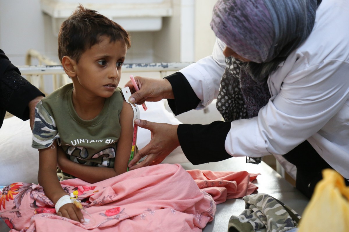 A child suffering from cholera has his arm measured by a health professional with a Mid-Upper Arm Circumference (MUAC) measuring tape to determine whether or not he is also suffering from malnutrition, at the Alsadaqah Hospital, Aden, Yemen, Monday 14 August 2017.

The world’s worst acute outbreak of acute watery diarrhea and cholera continues spreading in Yemen. Between late-April and July 2017, 436,625 suspected cases and 1,915 deaths had been reported in 21 of 22 governorates. Health, water and sanitation systems are struggling to function as a result of the ongoing conflict, and lack of regular salary payments for many public sector workers have created the ideal conditions for the disease to spread.

As part of efforts to halt the spread of AWD/cholera, UNICEF and its partners are reaching out to communities through a nationwide awareness campaign. Across Yemen, thousands of volunteers are going from house to house to raise awareness and provide advice to families on how they can best protect themselves from the potentially fatal infection. The teams provide 15 to 20 minutes of counselling, followed by demonstrations on how to properly wash hands with soap before eating food or after going to the bathroom. They also stress the importance of boiling water before drinking. The campaign is expected to reach 3.5 million families across the country.