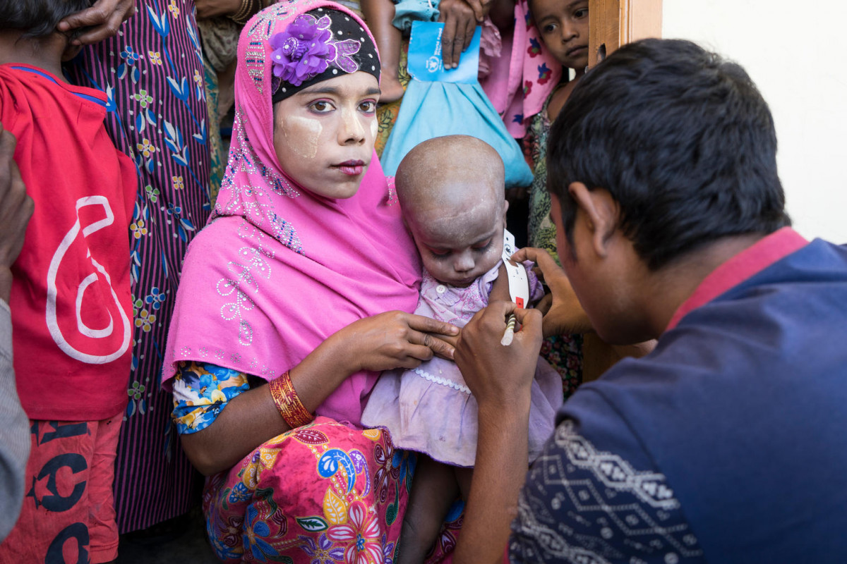 21 December 2017.  A Rohingya woman holds her little girl as her upper arm is measured to determine whether she is malnourished at a UNICEF-supported outpatient nutrition center in Thae Chaung village in Central Rakhine, Myanmar. Rakhine state has long been among the poorest in Myanmar, and the indicators for children are poor. Since the round of violence that started in 2012, things have not improved for children.

Background: https://www.unicef.org/media/media_102378.html
