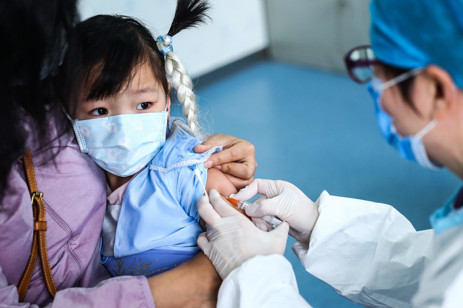 A 3-year-old girl receives a vaccine shot at a community health centre in Beijing, China, on 26 March 2020. Provinces other than Hubei, the epicenter of the COVID-19 outbreak, gradually resumed full vaccination services that had been halted due to the outbreak.