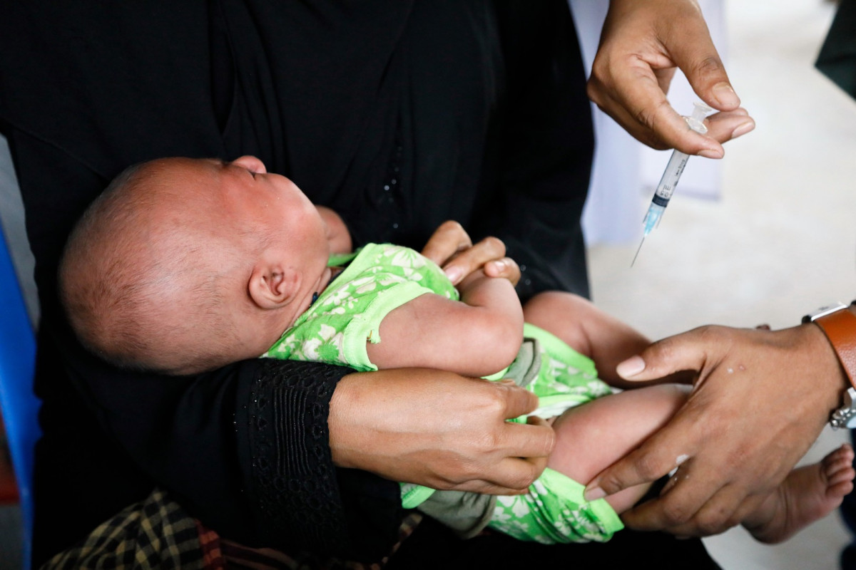A baby in a Balukhali refugee camp health center in Cox’s Bazar, Bangladesh, receives a pneumococcal conjugate vaccine (PCV) shot to protect her against pneumococcal disease as part of her routine immunization. Rohingya refugees have been included in Bangladesh’s routine immunization program since the beginning of the year. 

UNICEF provides different forms of support to governments in strengthening their immunization systems. Depending on which country the program is in, support can include vaccine procurement, supply-chain strengthening, training, emergency vaccination campaigns and communication.