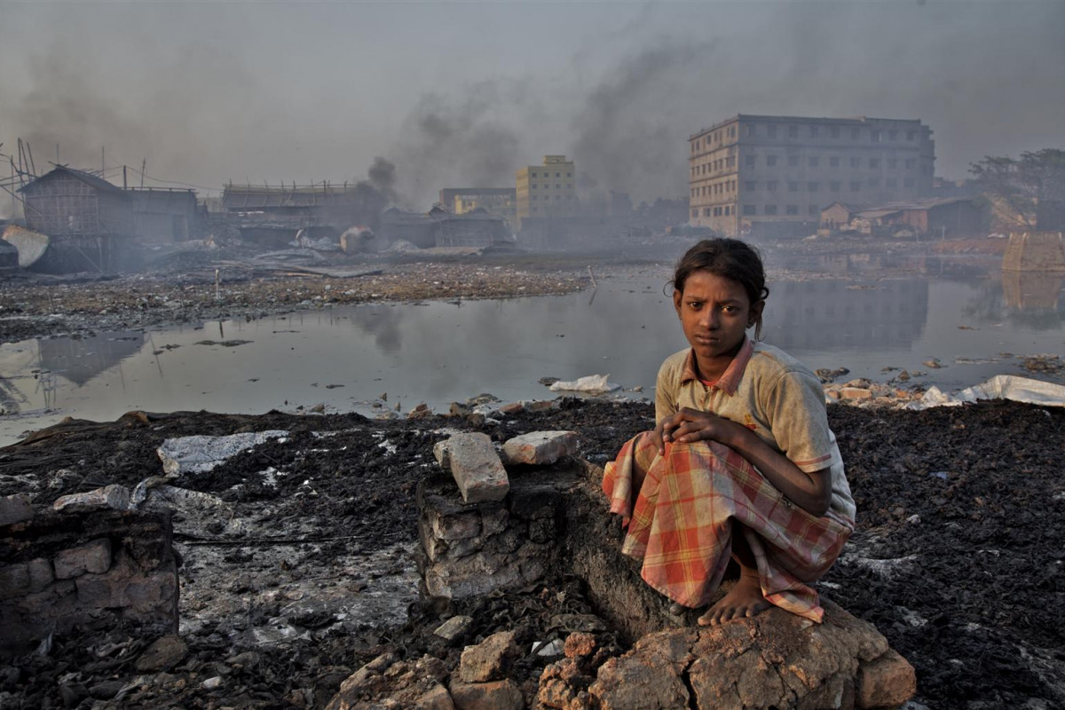 A young girl sits on broken wall inside an informal glue factory where workers process  waste leathers to make glue in Hazaribagh area near Buriganga river in Dhaka.

Most industries based in urban area in Bangladesh pollute environment but leather tanneries probably do the worst damage. Hazaribagh, Dhaka?s biggest leather processing industrial zone, is right in the middle of one of the most densely populated residential area.