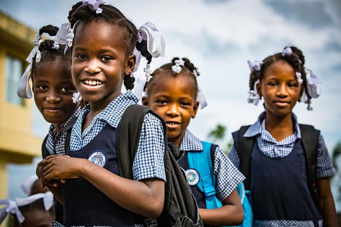 On 23 November 2016 in Haiti, (left to right) Élodie (7), Givelore (8), Francesca (6), Érica (8) gather outside their school, the Notre Dame de Lourdes school, in Jérémie.

By 4 January 2017, UNICEF had completed the restoration of 14 schools, with another 107 in various stages of progress. These restored schools have made it possible for 4,200 students to return to class. In total, its expected that over 36,000 students will return to the schools rehabilitated by UNICEF.

Almost three months after hurricane Matthew struck Haiti on 4 October 2016, UNICEF and its partners continue to deliver humanitarian aid to those most affected by the category 4 storm. Over 2 million people including 900,000 children were affected by the hurricane, of which 1.4 million require humanitarian assistance including 600,000 children.  In addition to the personal losses of homes and crops, over 716 schools, and many health facilities and the existing sanitation infrastructure all suffered damage.

"Three months after Matthew, we can already see improvements: safe water is increasingly available, the vast majority of schools have reopened as have a number of health facilities; and areas that are the most difficult to access are receiving assistance. UNICEF is continuing to fulfil its mandate and obligations to emergency and development efforts," said UNICEF Representative in Haiti Marc Vincent.

Hurricane Matthew passed over Haiti with heavy rains and winds. While the capital Port-au-Prince was mostly spared from the hurricane's full strength. The western area of Grand'Anse, however, was in the direct path. The cities of Les Cayes and Jeremie received full force sustaining winds and water damage across wide areas. Coastal towns were severely damaged as were many homes in remote mountainous regions. An estimated 500,000 children live in the Grand'Anse and South departments, the areas worst hit by Hurricane Matthew.