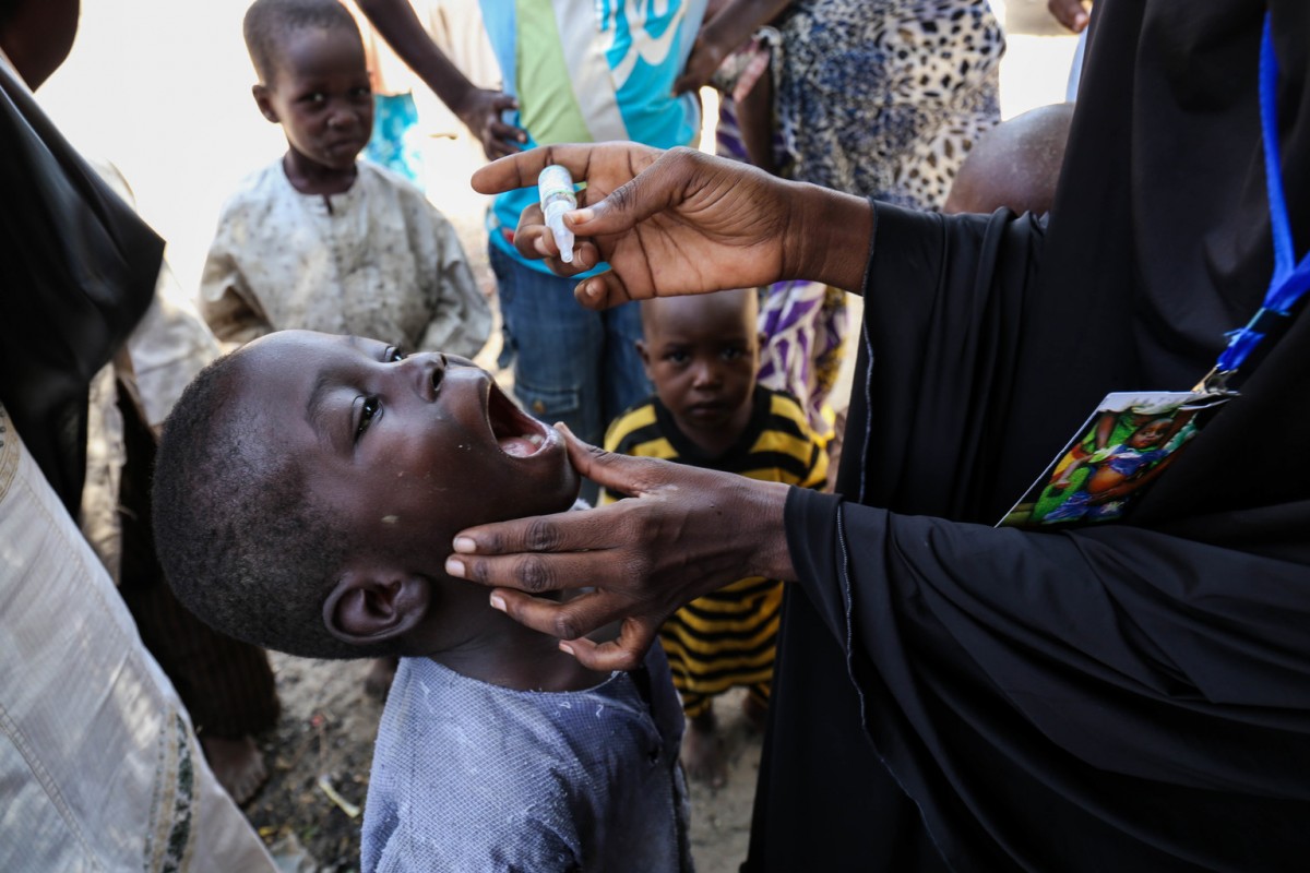 On 18 October 2016, Saleh, 6 years old, is vaccinated against polio in Jiddari Polo, Maiduguri.  An emergency polio immunization campaign took place from 15-18 October and includes nearly 39,000 health workers deployed to deliver polio vaccines to children under 5 years of age in high-risk areas in Nigeria, as well as in neighbouring Chad, Niger, Cameroon and Central African Republic to contain a polio outbreak in north-eastern Nigeria. Polio vaccination teams in parts of Borno State, Nigeria are also conducting simultaneous malnutrition screenings to identify severe acute malnutrition in children under five, referring malnourished children to therapeutic treatment programs. The immunization campaign is being delivered by national governments with support from UNICEF, the World Health Organization, Rotary International, US Centers for Disease Control and Prevention, and the Bill & Melinda Gates Foundation.