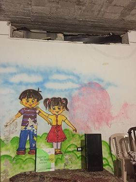 © UNICEF Syrian Arab Republic/2016/Khan A mural on the wall of one of the underground classrooms. The school is housed in a basement for safety reasons.