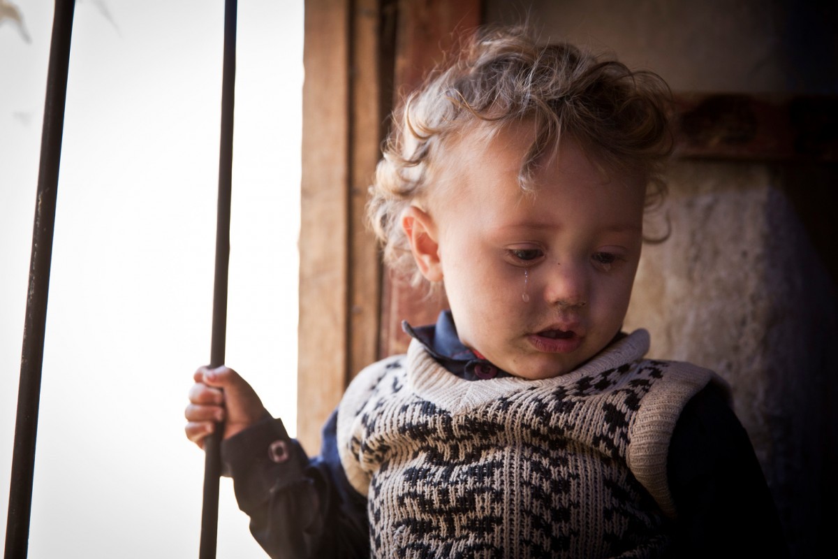 A Muhamasheen child is seen inside her house in the Muhamasheen area of Mathbah, in Sana'a, Yemen, November 2, 2015.

Yemen is suffering and its people are facing some of the worst moments in human history. This extreme hardship is affecting the most vulnerable of the Yemeni society. The absence of any coping mechanism for such vulnerable households is further pushing millions of Yemenis into extreme poverty.  This tragic turn is exacerbated by the suspension of the Social Welfare Fund (SWF) since March 2015, which has been the key "public social protection" buffer, covering almost 7.9 million Yemeni lives. Out of these poverty stricken millions, are an even further marginalized group known as the Muhamasheen. They survive on the fringes of society, living in slums and peripheral areas of urban, semi-urban, and rural Yemen. But the recent conflict has not been the sole cause of their misery. This community has been neglected for a fairly long time. With limited access to basic social services, their social indicators are far worse than that of any average citizen. And now the conflict has worsened their condition to a question of survival.

In December 2015, a recently concluded Muhamasheen Mapping Survey (MMS) has indicated that only 25 % of all Muhamasheen have durable housing, compared to 54 % of the general population; only 9% have access to piped water compared to the national figure of 29%; almost 22 % have to survive out in the cold, living in tents and makeshift hutments made of tin and cardboard; the majority 59% live in dilapidated and deserted houses. The statistics for the affected children is a lot worse: almost 52% of their children between ages 10 -14 age group, cannot read and write, compared to 17% at the national level and 40% of the poorest quintile; for the age group of over 15 years, 80% cannot read and write, compared to 40% of the same group at the national level, and 68% of poorest quintile. 

The Social Welfare Fund exclusion error margin