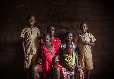 © UNICEF Burundi/2016/Haro Aimable and his family. After seven years of living on the streets with his brother, the Kabondo Football for Hope Centre helped him return home.